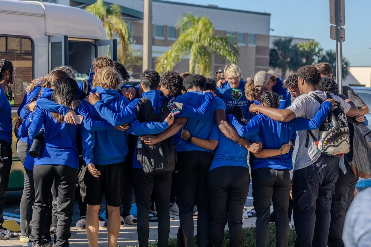 Track & Field send-off! Students pray before boarding the bus.